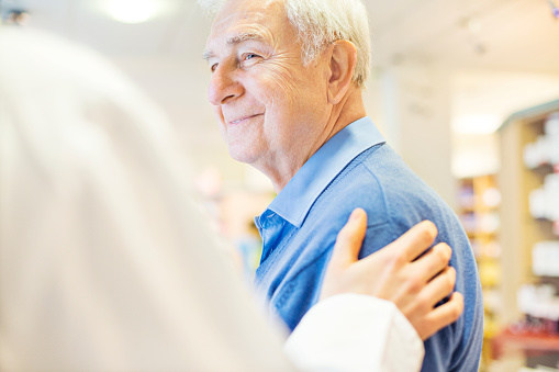 Smiling senior man looking at family dentist at Dens Dental Studio in Uptown Chicago, IL.