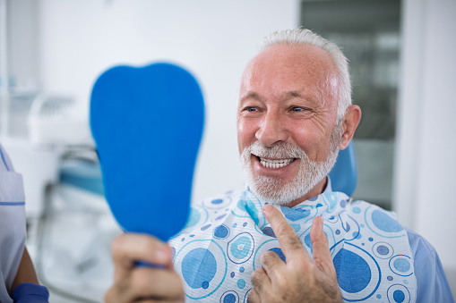 Smiling and satisfied patient after emergency treatment at Dens Dental Studio in Uptown Chicago, IL.