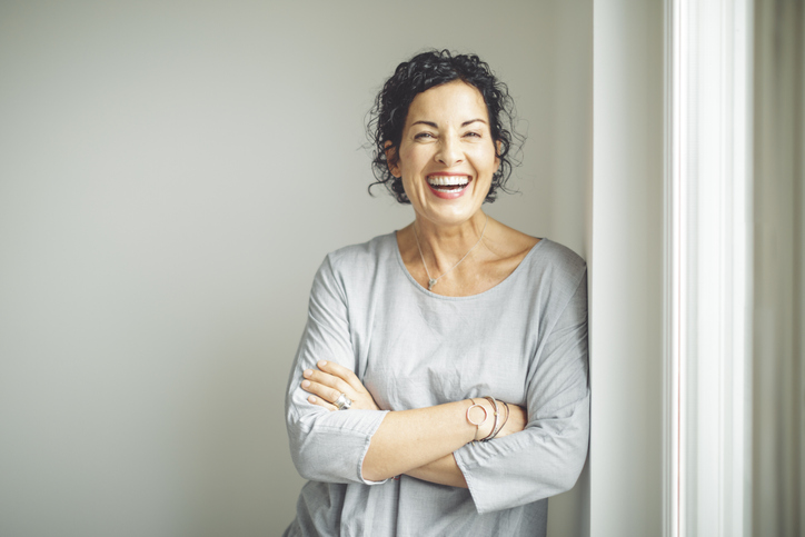 Older woman smiling and laughing after emergency treatment at Dens Dental Studio in Uptown Chicago, IL.