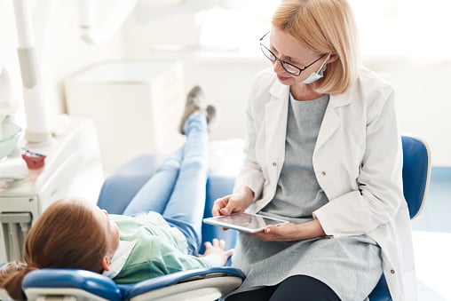 Dentist listening to patient with dental anxiety at Dens Dental Studio in Chicago, IL