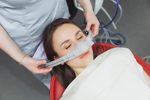 Young woman receiving dental sedation at Dens Dental Studio in Chicago, IL